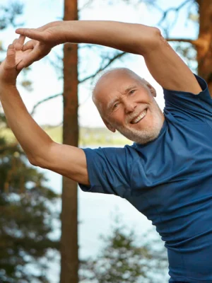 outdoor-shot-happy-energetic-senior-retired-man-enjoying-physical-training-park-doing-side-bends-exercise-holding-hands-together-with-broad-smile-warming-up-body-before-run_343059-4749